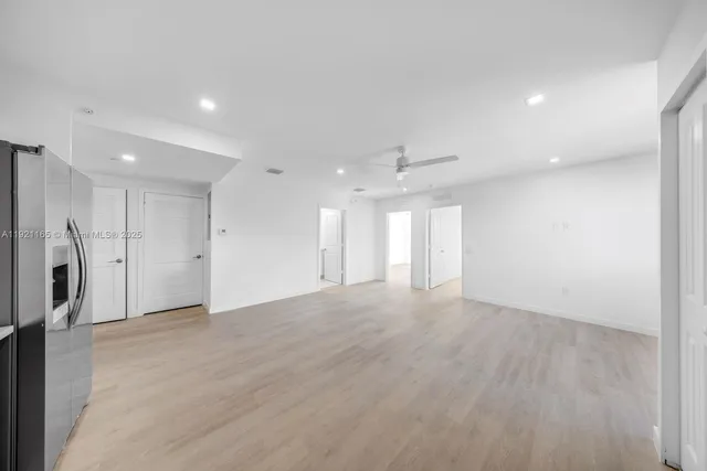 an empty room with a garage and a glass door