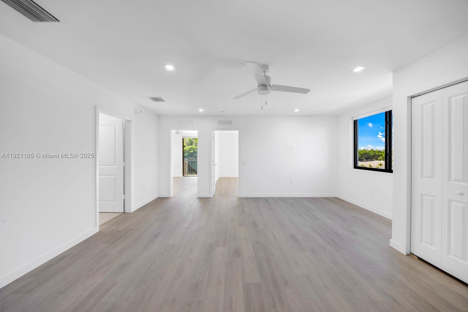 20 Northeast 19th Avenue, Unit 201 Pompano Beach, FL 33060 - Photo 4 of 25 a view of an empty room with wooden floor