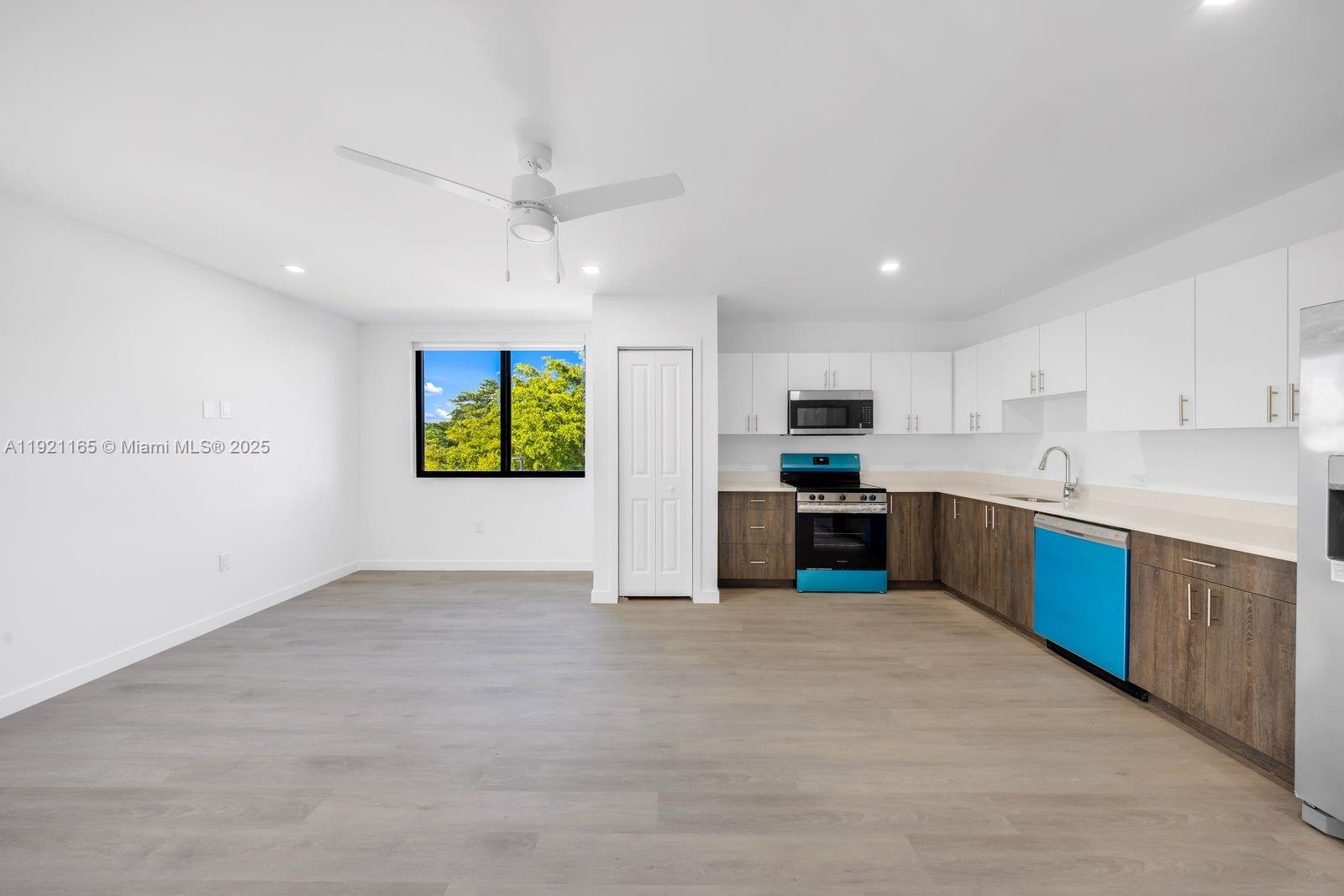20 Northeast 19th Avenue, Unit 201 Pompano Beach, FL 33060 - Photo 5 of 25 a large kitchen with a stove a sink dishwasher and a refrigerator