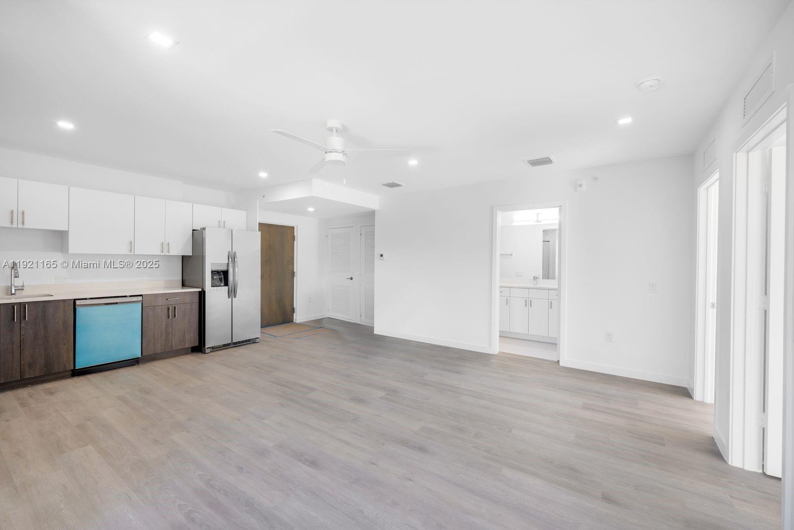 20 Northeast 19th Avenue, Unit 201 Pompano Beach, FL 33060 - Photo 7 of 25 a view of a kitchen with a sink and a refrigerator