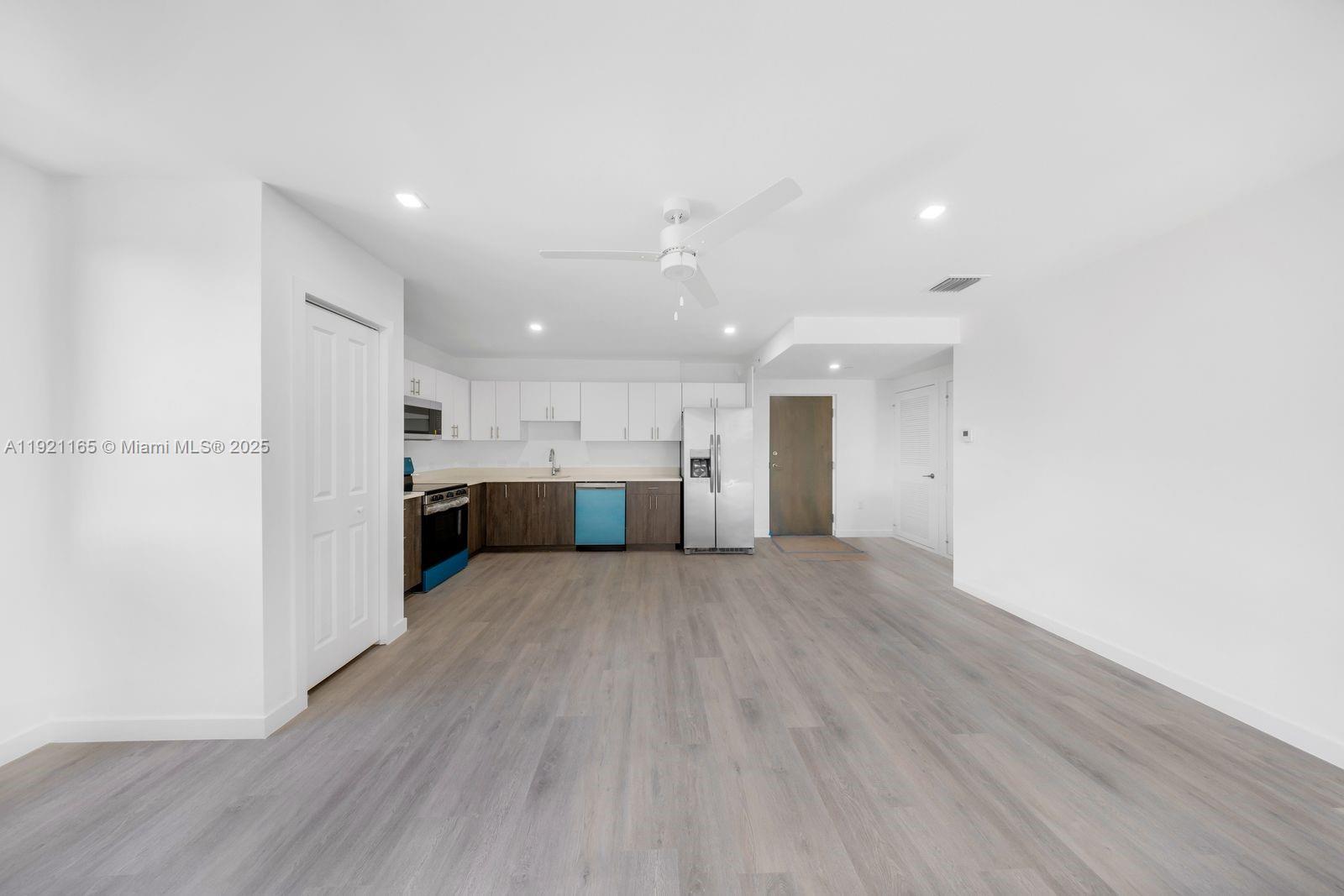 20 Northeast 19th Avenue, Unit 201 Pompano Beach, FL 33060 - Photo 8 of 25 a view of kitchen with wooden floor