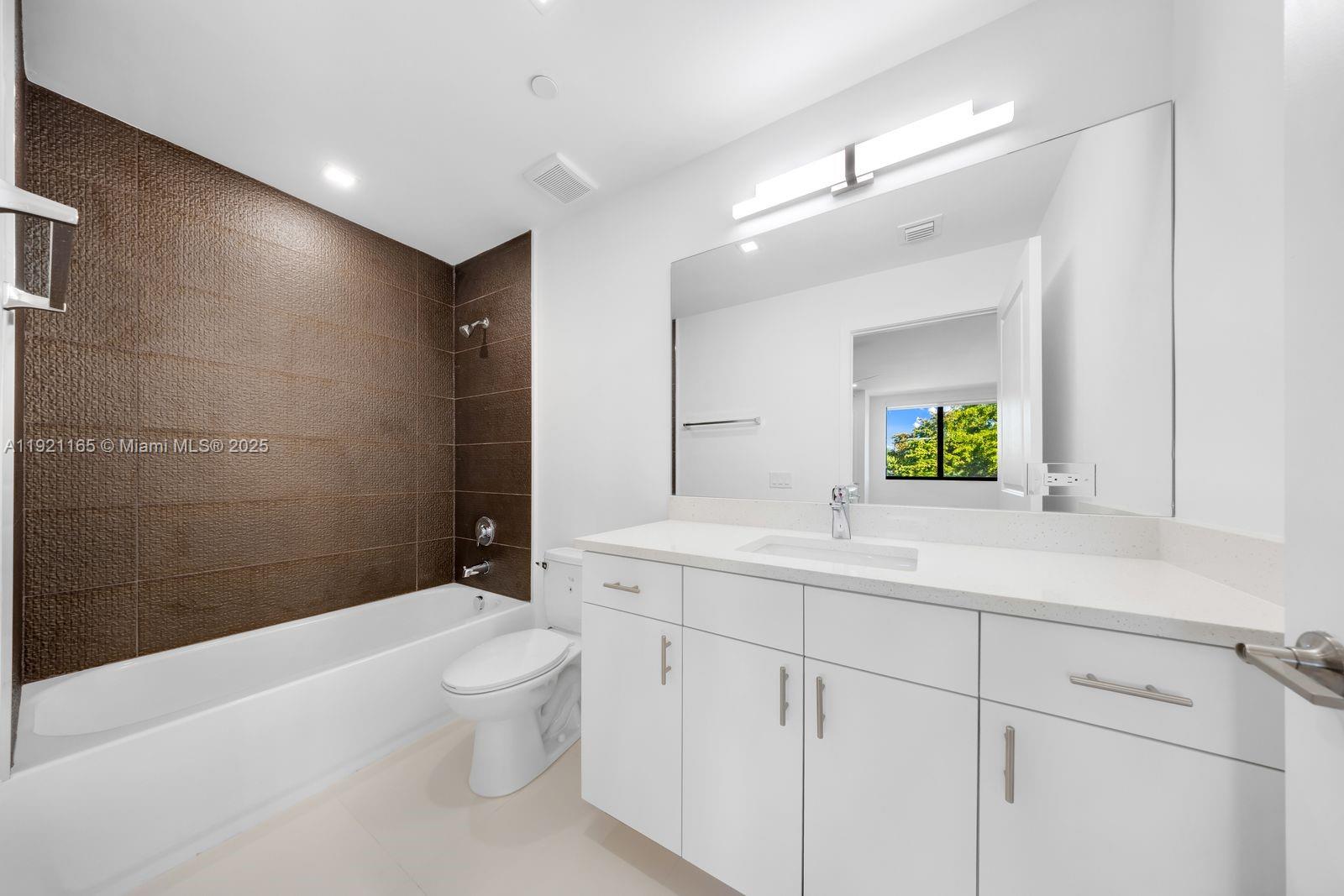 20 Northeast 19th Avenue, Unit 201 Pompano Beach, FL 33060 - Photo 10 of 25 a bathroom with a sink a toilet and shower