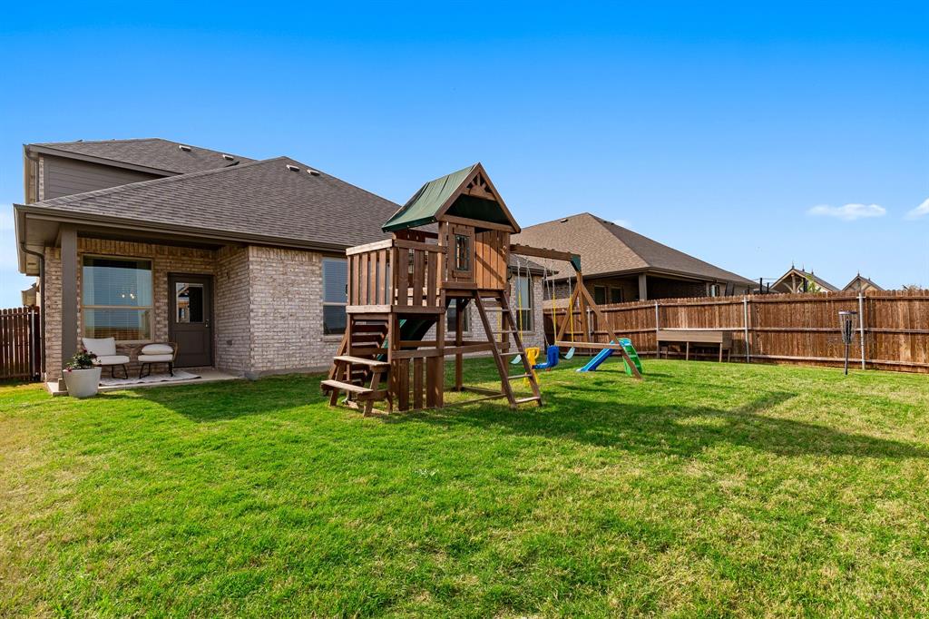 1125 Knightsbridge Road Argyle, TX 76226 - Photo 21 of 27 a view of a house with a big yard and large trees