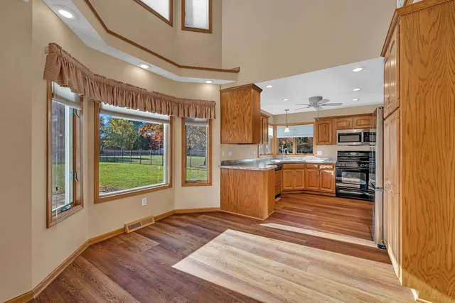 a view of a kitchen with kitchen island a counter top space a sink and cabinets