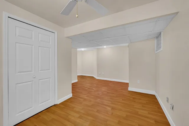 a view of an empty room with wooden floor