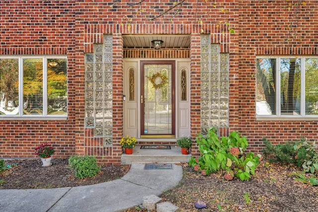 a front view of a house with a garden