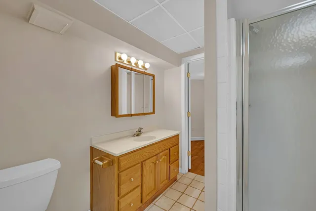 a bathroom with a sink toilet and shower