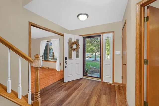 a view of entryway and hall with wooden floor
