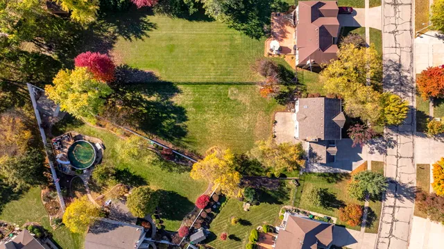 an aerial view of residential house with outdoor space and swimming pool