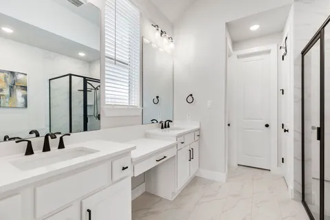 a bathroom with a double vanity sink mirror and double