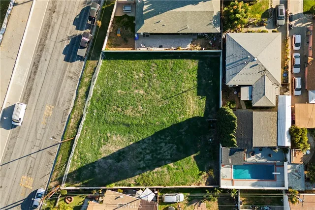 an aerial view of a residential houses with yard