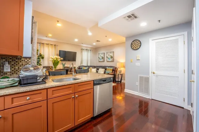a kitchen with stainless steel appliances granite countertop a sink and cabinets