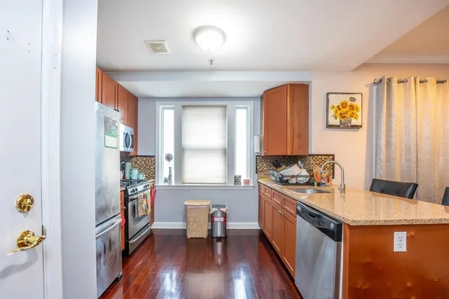 a kitchen with a sink appliances and a window