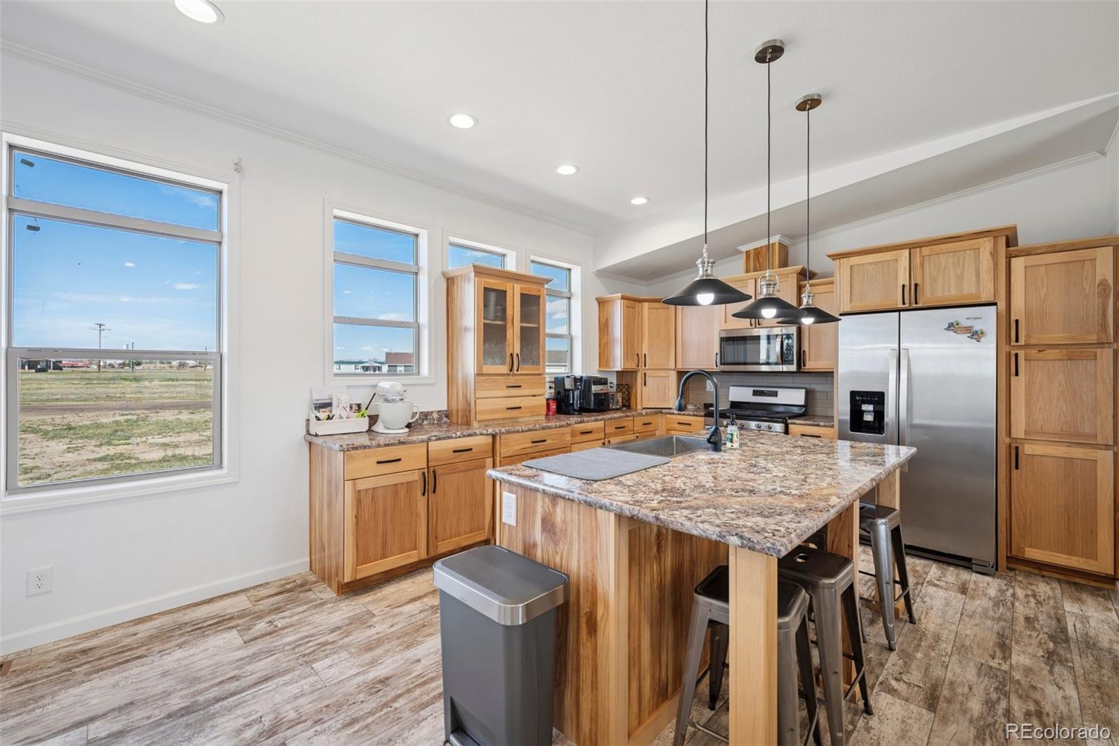 311 Silver Street Hugo, CO 80821 - Photo 16 of 33 a kitchen with stainless steel appliances granite countertop a sink stove and refrigerator