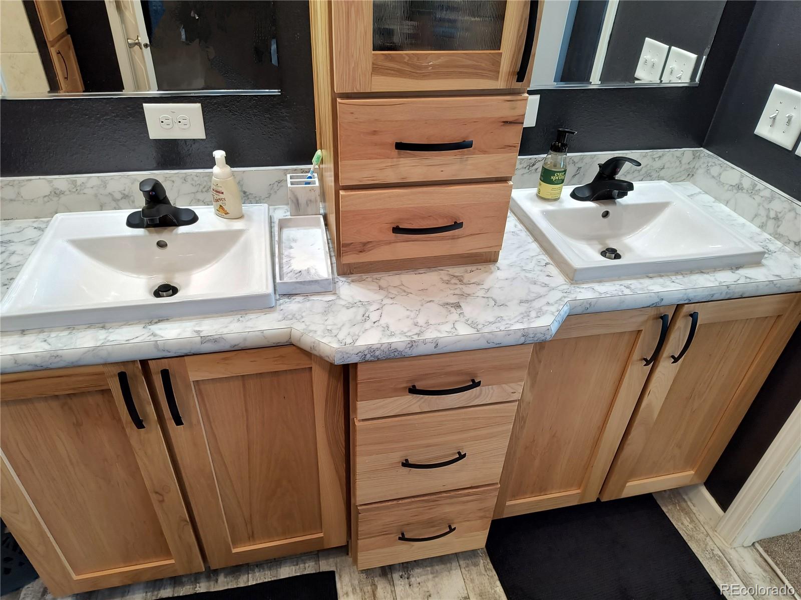 311 Silver Street Hugo, CO 80821 - Photo 26 of 33 a bathroom with a sink and a mirror