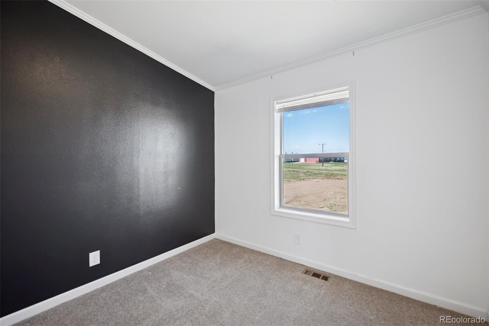 311 Silver Street Hugo, CO 80821 - Photo 27 of 33 an empty room with a window