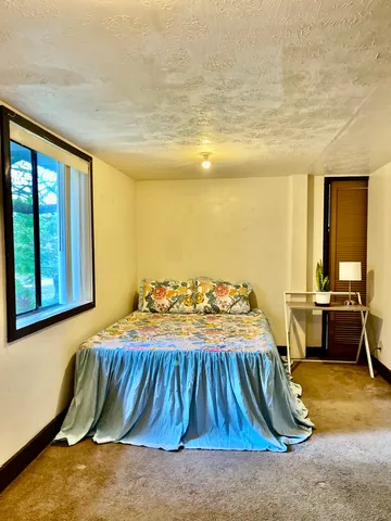 a bedroom with a bed and painted walls