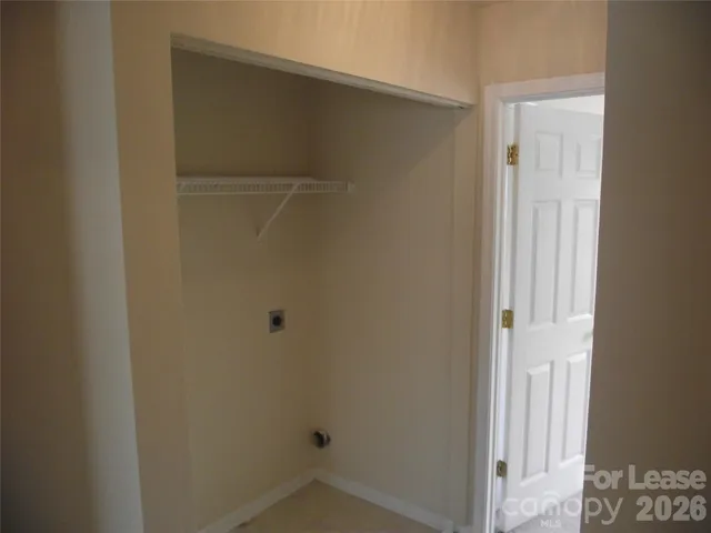 a small space with wooden floor and a window