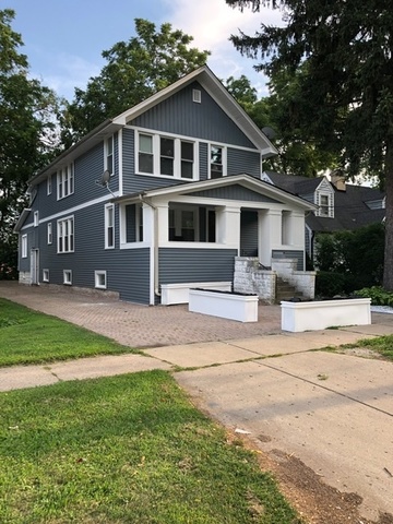 305 West Palatine Road, Unit 2 Palatine, IL 60067 - Photo 1 of 8 a front view of a house with a yard
