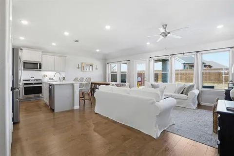 a living room with furniture and kitchen view