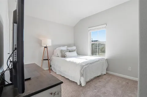 a bed room with a bed and a window