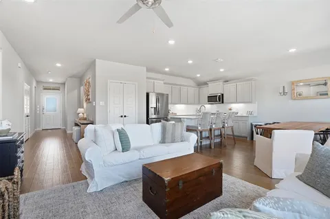 a living room with furniture and kitchen view
