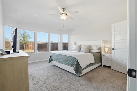 a spacious bedroom with a bed and a large window