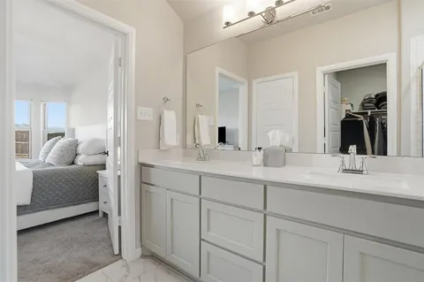 a bathroom with a double vanity sink and mirror