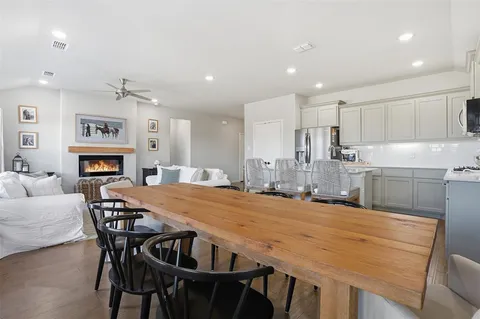 a kitchen with kitchen island a stove a table and chairs