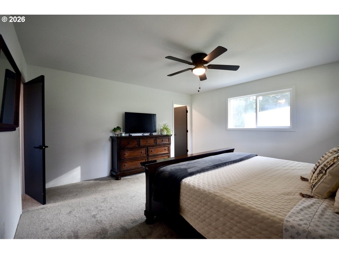 10854 Summit Loop Road Southeast Turner, OR 97392 - Photo 15 of 35 a bedroom with a bed and a tv on the dresser