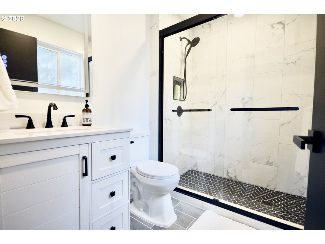 10854 Summit Loop Road Southeast Turner, OR 97392 - Photo 16 of 35 a bathroom with a sink toilet and shower
