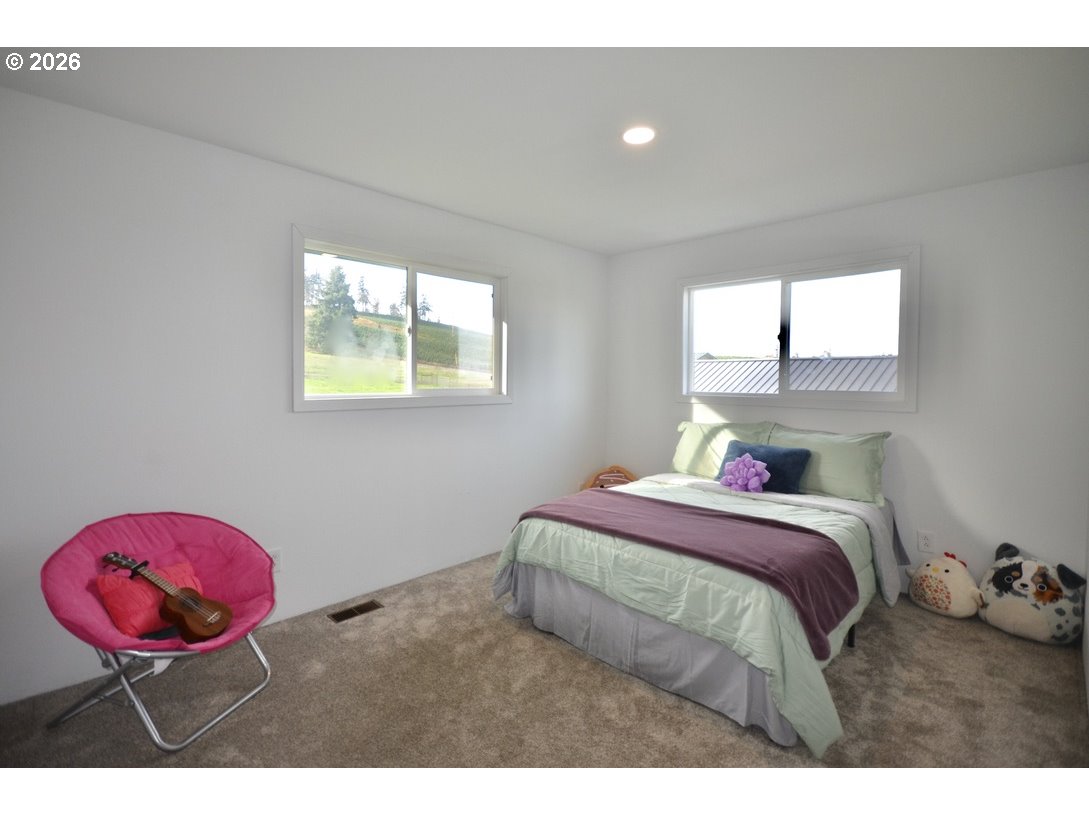 10854 Summit Loop Road Southeast Turner, OR 97392 - Photo 17 of 35 a bedroom with a bed with wooden floor