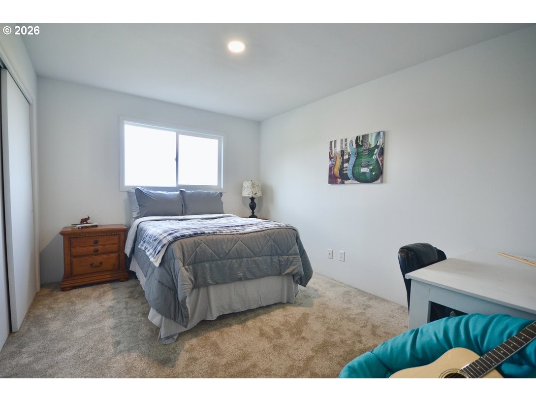 10854 Summit Loop Road Southeast Turner, OR 97392 - Photo 18 of 35 a bedroom with a bed and a large window
