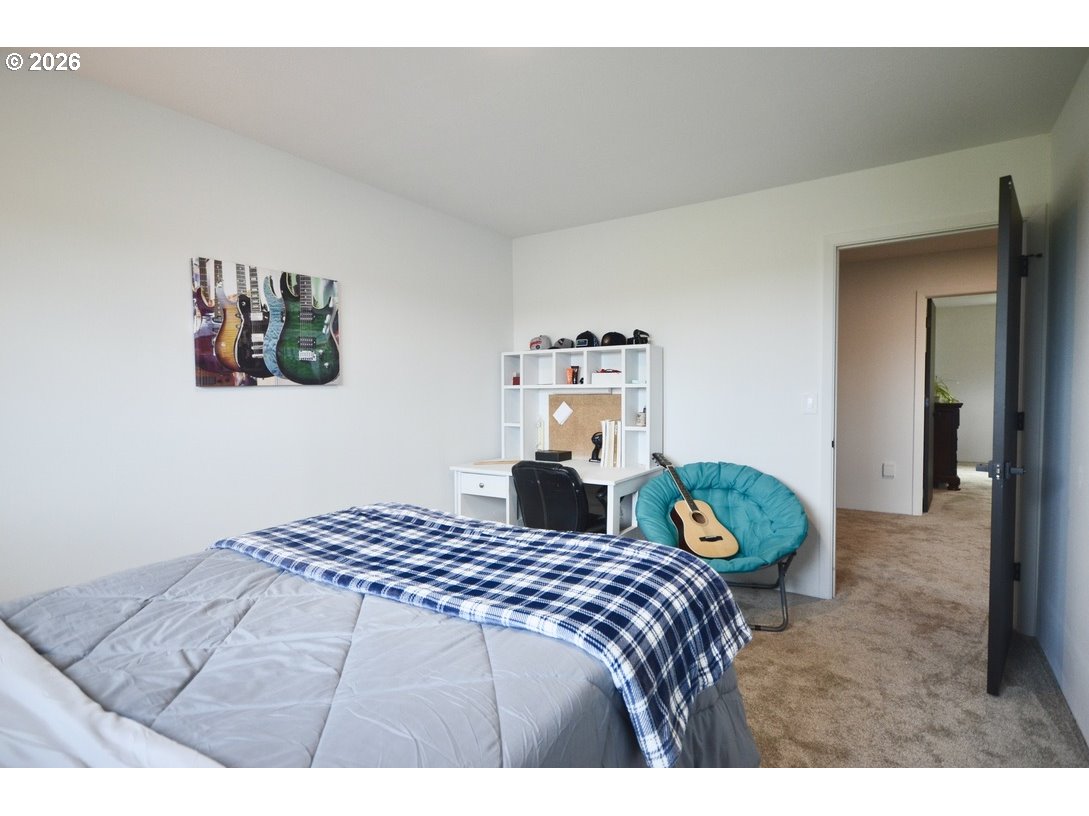 10854 Summit Loop Road Southeast Turner, OR 97392 - Photo 19 of 35 a bedroom with a bed and a painting on the wall