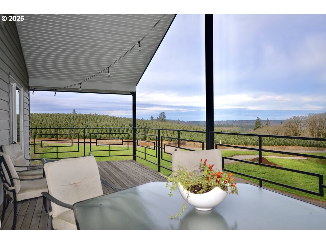 10854 Summit Loop Road Southeast Turner, OR 97392 - Photo 24 of 35 a view of a patio with a dining table and chairs