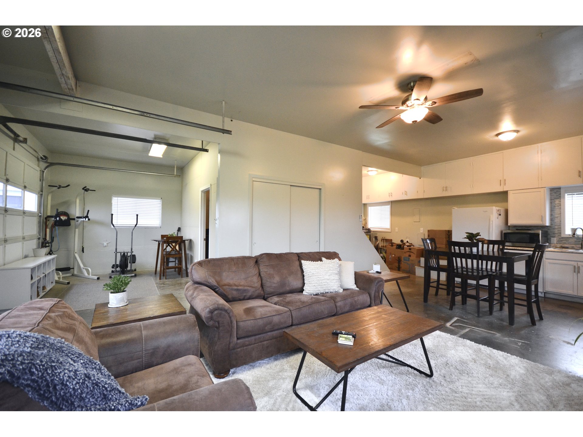 10854 Summit Loop Road Southeast Turner, OR 97392 - Photo 30 of 35 a living room with furniture a wooden floor and chandelier