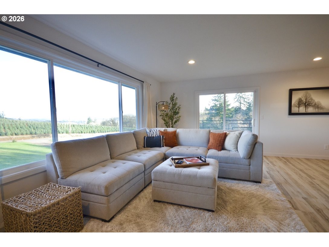 10854 Summit Loop Road Southeast Turner, OR 97392 - Photo 6 of 35 a living room with furniture and a floor to ceiling window