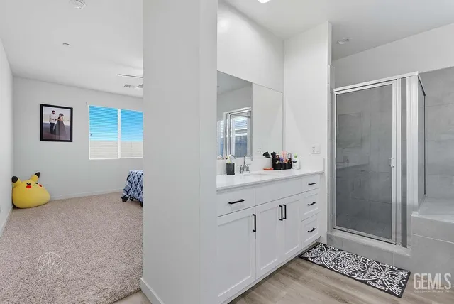 a bathroom with a tub shower and mirror