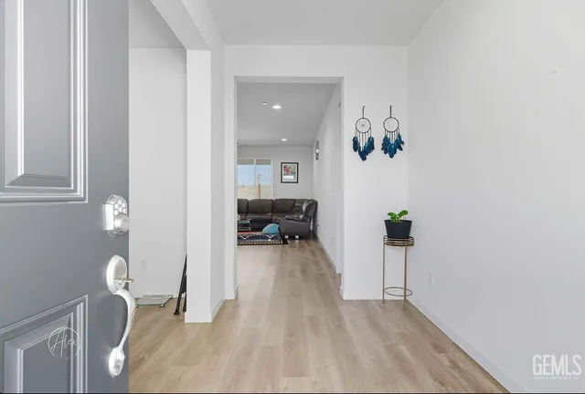 wooden floor with table and chairs