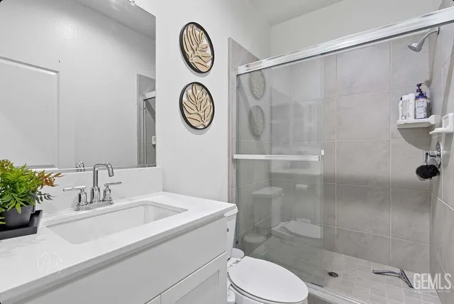 a bathroom with a toilet sink and shower