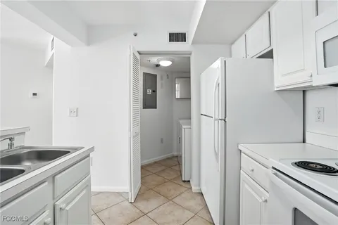a kitchen with cabinets and stainless steel appliances