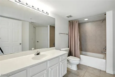 a bathroom with a toilet a sink a bathtub and a mirror