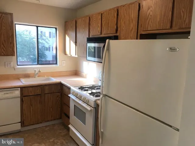 a kitchen with a refrigerator stove and sink