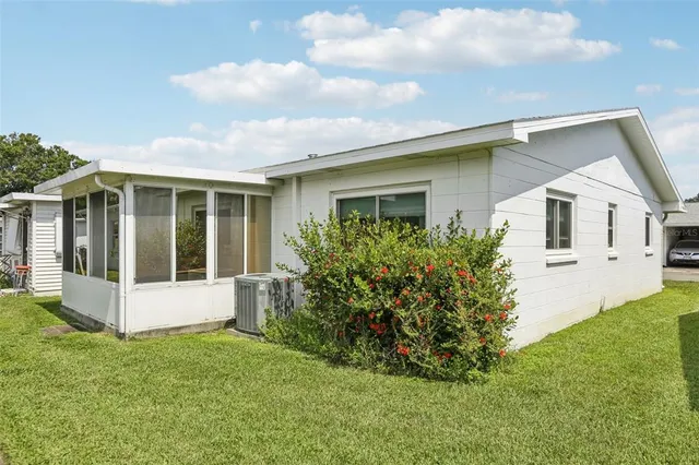 a view of an house with backyard space and garden