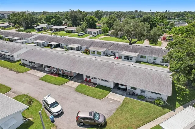 an aerial view of a house with a yard and lake view