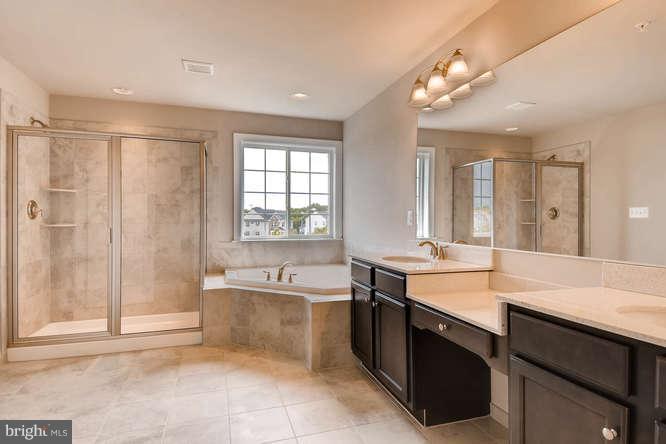 4317 Forge Road Perry Hall, MD 21128 - Photo 11 of 20 a large bathroom with a sink mirror and a bath tub