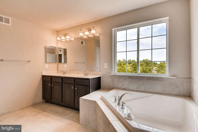 4317 Forge Road Perry Hall, MD 21128 - Photo 12 of 20 a bathroom with a tub sink and mirror