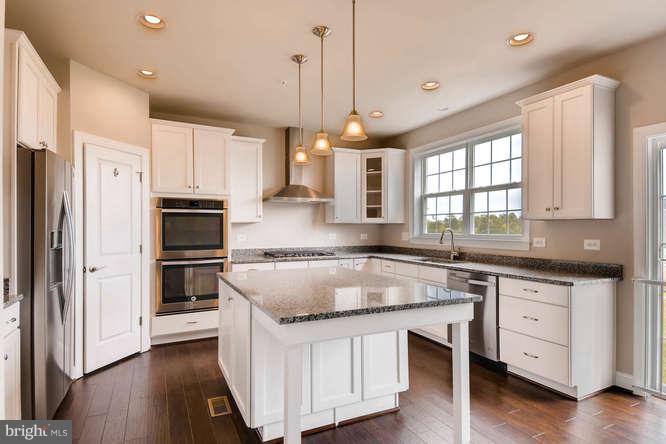 4317 Forge Road Perry Hall, MD 21128 - Photo 6 of 20 a kitchen with granite countertop a sink appliances cabinets and wooden floor