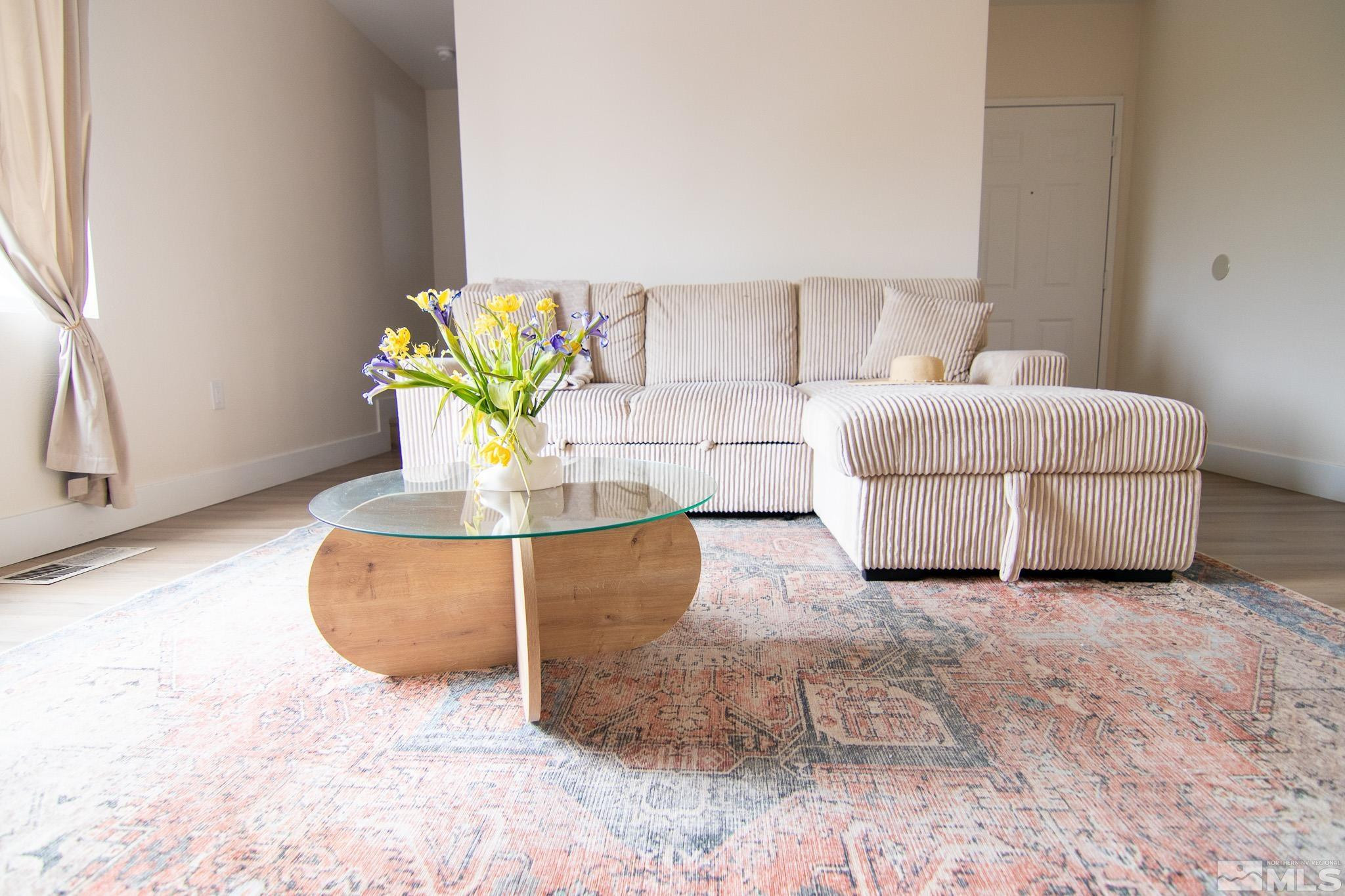 100 Bisset Court, Unit B Reno, NV 89503 - Photo 1 of 31 a living room with couches and a potted plant
