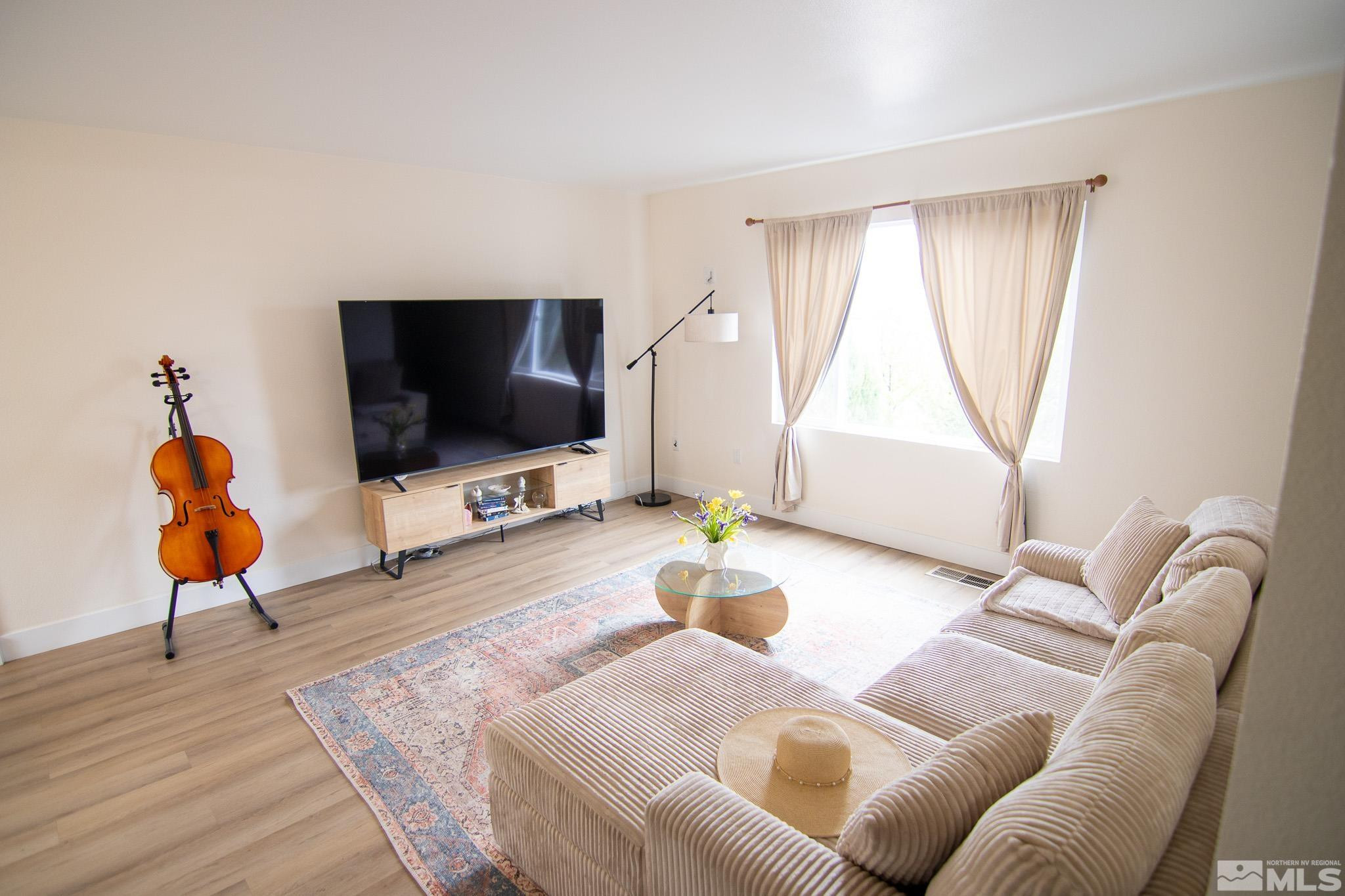 100 Bisset Court, Unit B Reno, NV 89503 - Photo 3 of 31 a living room with furniture and a flat screen tv
